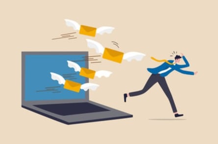 Email overload and businessman running away from emails | Theia Marketing